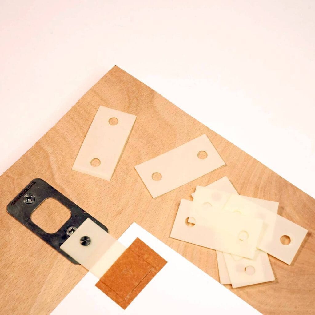 Registration pin fixed to a board with a tab attached to the paper