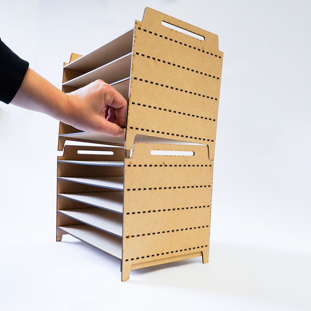 Two print drying rack units being aligned at the stacking joint
