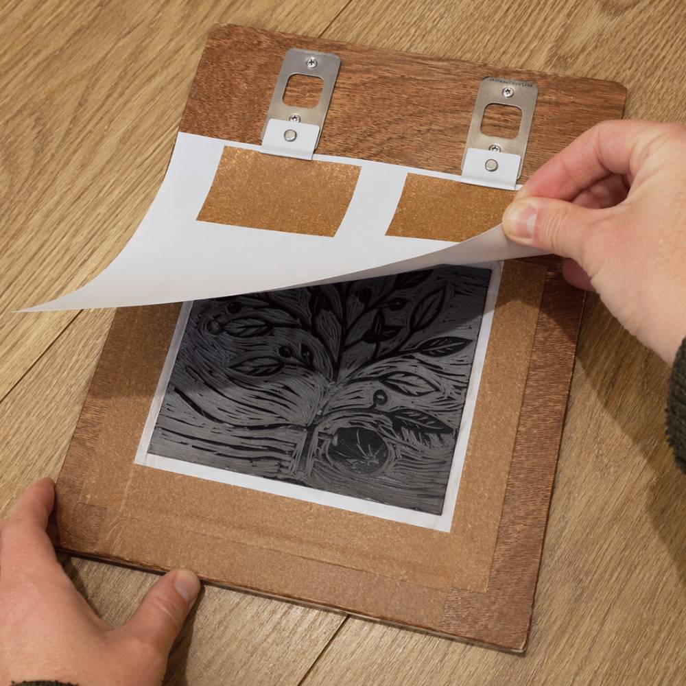 Inked lino block aligned using Hickman Design registration pins