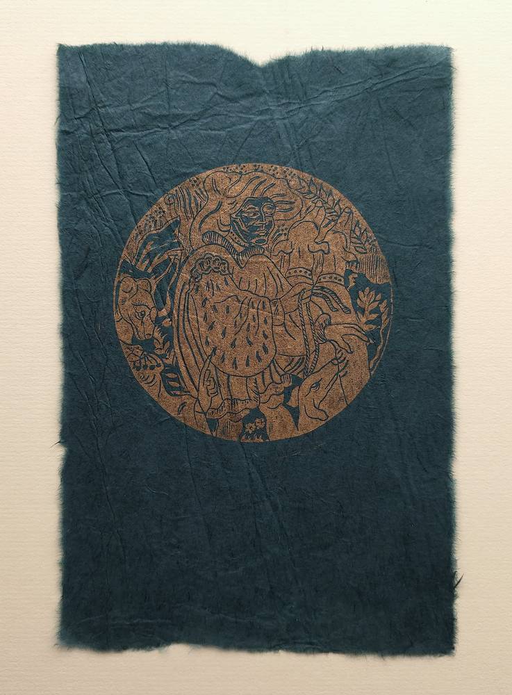 Moatzart’s The Bear III linocut, with a copper-coloured circular scene of a figure, animals and foliage on dark blue handmade paper.